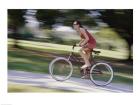 Side profile of a young woman riding a bicycle