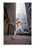 Side profile of a young man running in a city