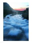 River flowing around rocks at sunrise, Sunrift Gorge, US Glacier National Park, Montana, USA