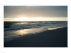 Waves breaking on the beach at sunrise