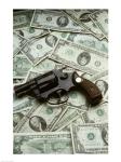 Close-up of a handgun with paper currency
