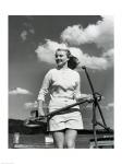 Young woman standing on boat, holding anchor