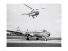 Low angle view of a helicopter in flight and an airplane at an airport, Sikorsky Helicopter, Douglas DC-4