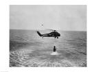 Marine helicopter lifting the astronaut spacecraft out of the Ocean