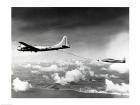 Side profile of a military tanker airplane refueling in flight, B-29 Superfortress, F-84 Thunderjet