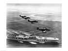 High angle view of four fighter planes flying over an aircraft carrier, US Navy Banshees, USS Coral Sea (CV-43)