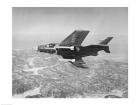 Side profile of a fighter plane carrying sidewinder missiles during flight, F9F-8 Cougar, US Navy