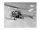 Low angle view of two people sitting in a helicopter, Bell 47G-2