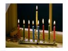 Close-up of a menorah with burning candles and a Star of David