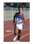 Male athlete running on a running track