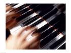 Close-up of a person's hands playing a piano