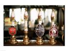 Close-up of beer tap handles in a bar, London, England