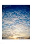 Low angle view of sunrise seen through clouds