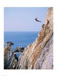 Male cliff diver jumping off a cliff, La Quebrada, Acapulco, Mexico