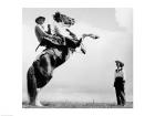 Low angle view of a cowboy riding a bucking horse