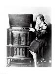 Young woman sitting beside an RCA Radio-Phonograph and Home Recorder