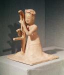 Seated musician playing a harp (painted terracotta)