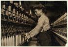 A doffer replaces full bobbins at Globe Cotton Mill, Augusta, Georgia, 1909 (b/w photo)