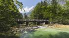 Visitors crossing bridge over the Sava Bohinjka river, on the edge of the Triglav National Park, Upper Carniola, Slovenia. (photo)