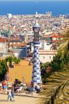 Barcelona, Spain. Parc Güell. Gran Plaça Circular. The central plaza. Barcelona cityscape in background. Guell Park was designed by Antoni Gaudi and is a UNESCO World Heritage Site.
