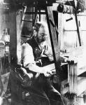 Man working at a handloom (b/w photo)