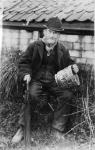 Edward Bingham holding one of his Castle Hedingham Ware designs (b/w photo)