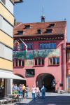 Appenzell, Appenzell Innerrhoden Canton, Switzerland. Visitors admiring the town hall facade in Hauptgasse, the main street.