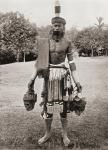 A Dayak, Dyak or Dayuh man from the island of Borneo, seen here in gala costume. Every year or two the Dayaks hold a feast called Gawai Autu in honour of the departed spirits which they believe surround the heads which hang in their houses. After a 19th c