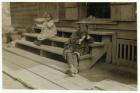 5 year old Olga Schubert began work about 5:00 A.M. helping her mother in the Biloxi Canning Factory, Mississippi, picking shrimps. She was tired out and refused to be photographed, 1911 (b/w photo)