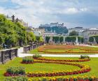 Salzburg, Salzburg State, Austria. View across the gardens of the Schloss Mirabell to the Hohensalzburg fortress.