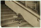 Newsboy asleep with his papers in Jersey City, New Jersey, 1912 (b/w photo)