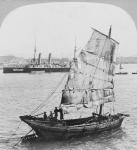 Chinese junk and British battleship in the harbour at Hong Kong, 1902 (b/w photo)