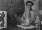 Henri Gaudier-Brzeska with his sculpture 'Bird Swallowing Fish' in Kettle's Yard, University of Cambridge, 1914 (b/w photo)