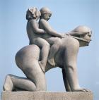 Woman with two children riding on her back (stone)