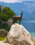 Lake Bohinj (Bohinjsko jezero), Triglav National Park, Upper Carniola, Slovenia. Statue of Zlatorog on the shore of the lake. Zlatorog is a mythical chamois with golden horns immortalized by German poet Rudolf Baumbach and the writings of Slovenian politi
