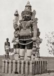 A village deity. A colossal statue of the gate-keeper god or Dvarapala, holding a gadha mace and with his attendants, in Tami?akam or the Ancient Tami? country, southern India. From Customs of The World, published circa 1913.