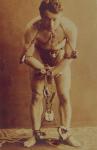 Harry Houdini in chains, c.1899 (b/w photo)