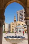 Izmir, Izmir Province, Turkey. Konak Square. The Yali, or Konak Mosque seen through an arch of the Clock tower.