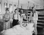 Taking a patient's pulse, Brooklyn Navy Yard Hospital, c.1890-1901 (b/w photo)