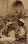 Harem girls smoking a hookah, from an early 20th century postcard (sepia photo)