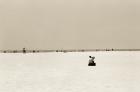 Man sitting on a beach playing his horn, 2004 (b/w photo)