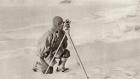 Captain Evans observing with the theodolite used by Captain Scott to fix position of the South Pole, from 'South With Scott' by E.R.G.R. Evans (b/w photo)