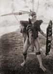 A Lirong warrior of the Baram District, Sarawak, Borneo, Malaysia. His coat was made of goat skin and his shield covered with human hair obtained from his enemies. The long feathers in his war cap were plucked from the helmeted hornbill and the rhinoceros