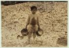 5 year old migrant shrimp-picker Manuel in front of a pile of oyster shells, working for a second year at Dunbar, Lopez, Dukate Company, Biloxi, Mississippi, 1911 (b/w photo)