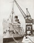 The RMS Mauretania docked and beingpainted. From The Story of 25 Eventful Years in Pictures, published 1935.