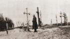 A Russian soldier at the grave of a comrade-in-arms during World War One, from 'The Illustrated War News', 1915 (b/w photo)