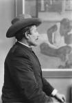 Paul Gauguin in front of his painting (b/w photo)