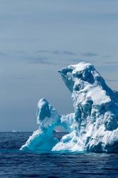 An arched iceberg floating in Gerlache Strait, Antarctica. | Obraz na stenu