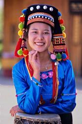 China, Yunnan, Young De'ang woman portrait with drum | Obraz na stenu
