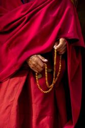 Hands of a monk in red holding prayer beads, Leh, Ladakh, India | Obraz na stenu